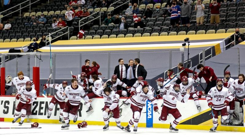 Players from Massachusetts celebrating a victory in college ice hockey.